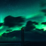 Bridge with aurora borealis over