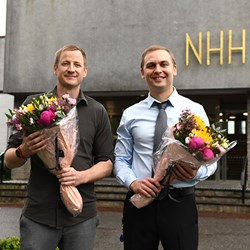 Berntsen and Belik holding flowers after getting promoted to professors