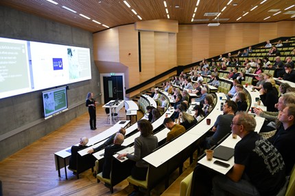 Sigrun on stage, the audience in AudMax listening