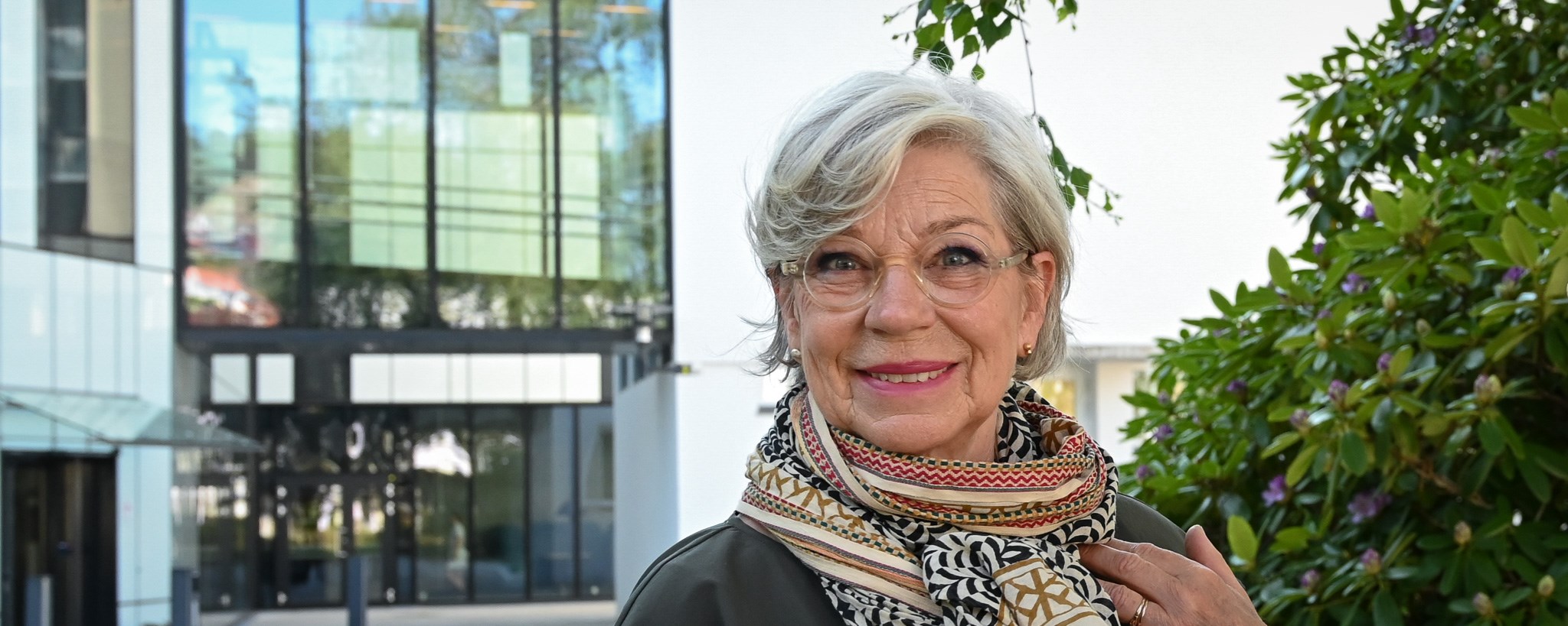 A smiling Ingeborg outside NHH campus