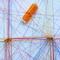 Pieces of string connected by a woood peg. Photo by Omar Flores on Unsplash