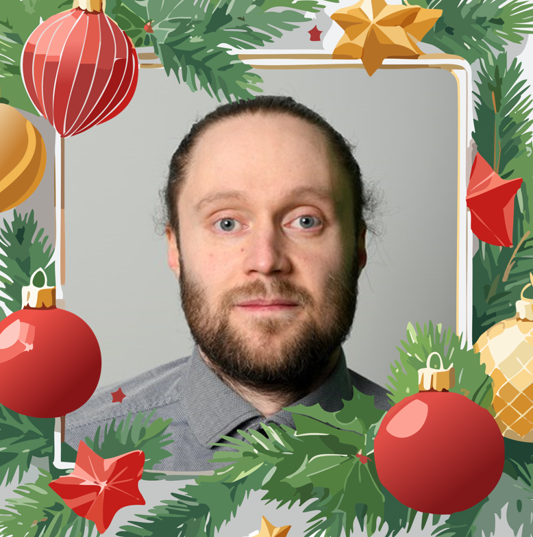 Portrait photo of Tomi with Christmas fram around