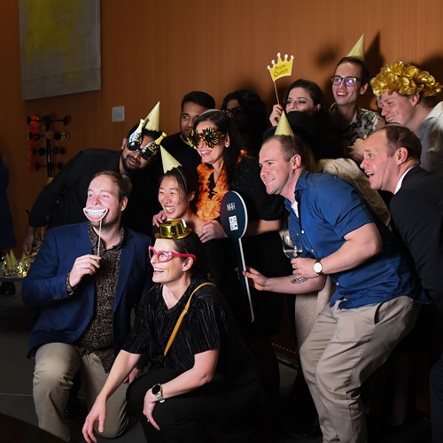 NHH eployees taking a group photo at an Autumn Party