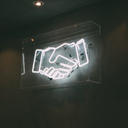 Neon handshake sign