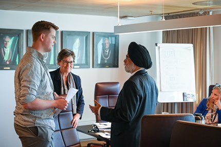 Three people talking in a meeting room