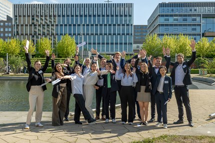 Group photo outside, people cheering 