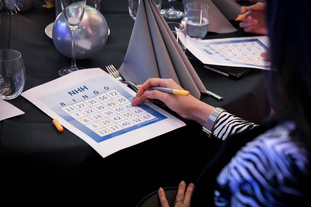 Person writing on bingo card