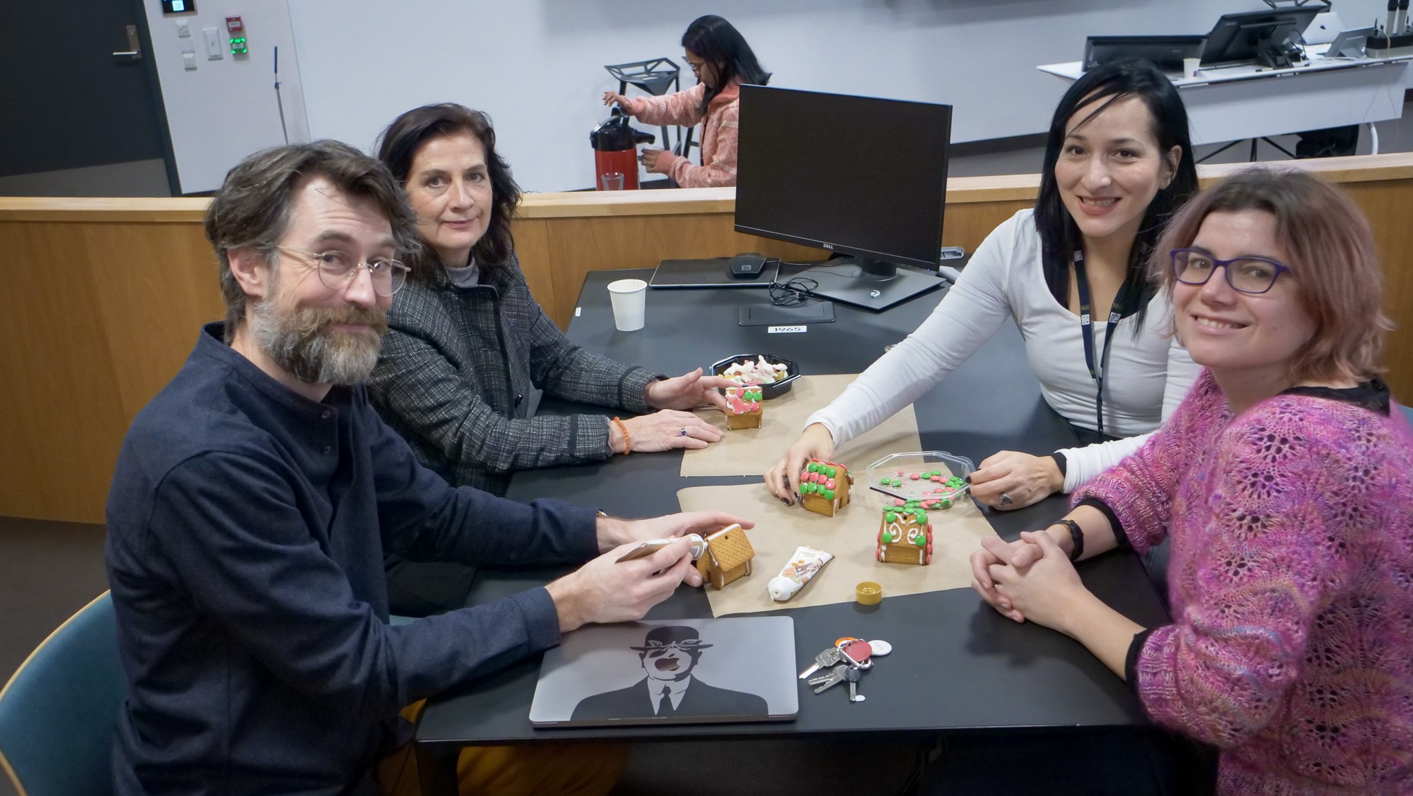 Four employees working together in a group, sitting at a table