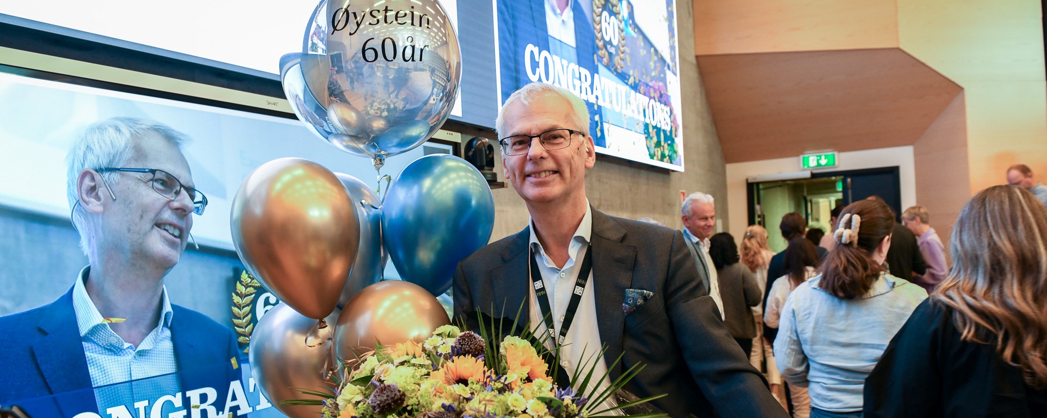 Øystein holding flowers and gift