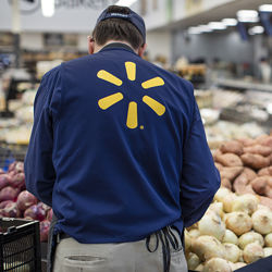 Walmart employee restocking. Walmart press photo
