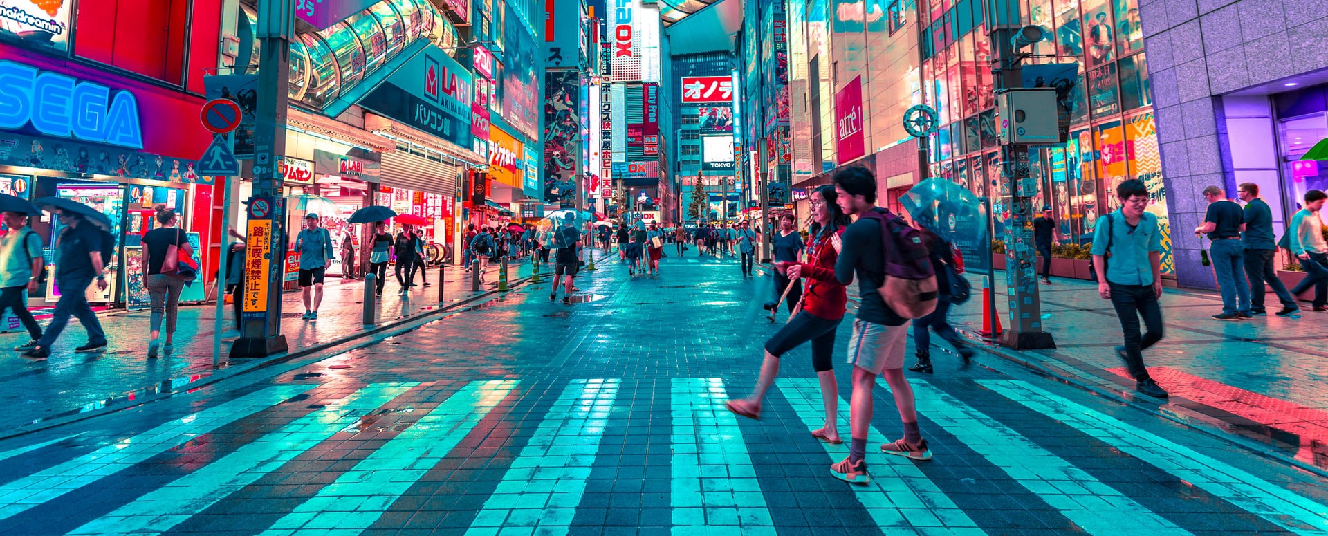 A photo of a shopping street lit by neon lights