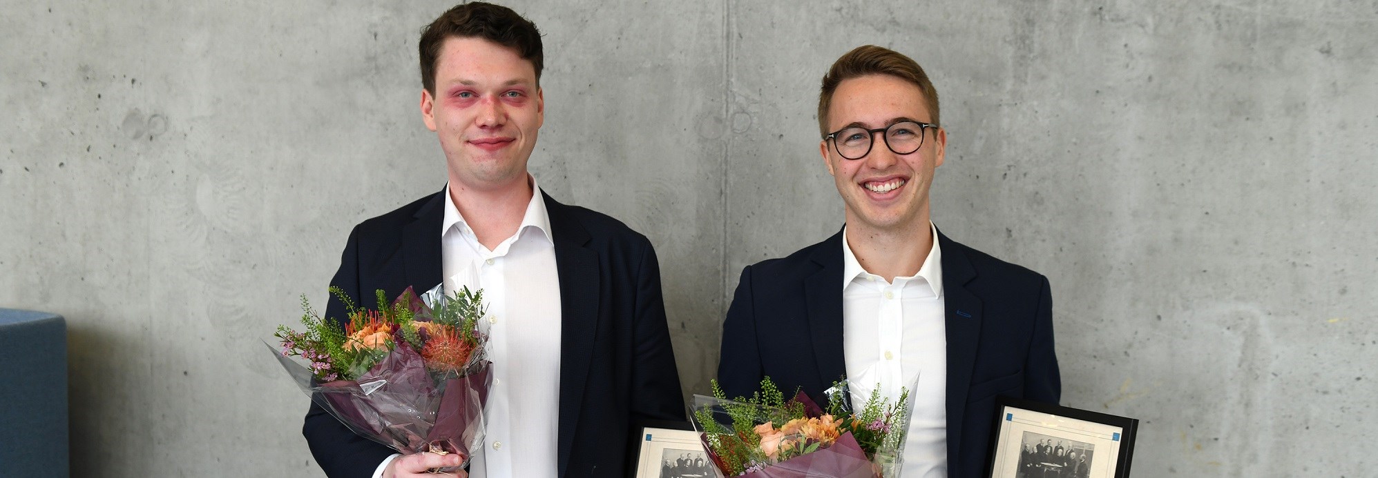 Winners in 2022 holding diploma and flowers